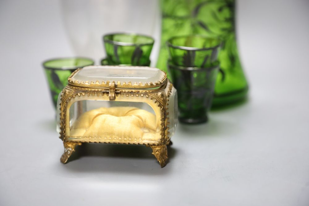 A 19th century French gilt-metal-mounted glass jewellery casket, a Venetian green glass liqueur set and a glass carafe,